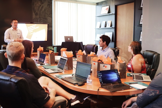 A host-company briefing around a conference table